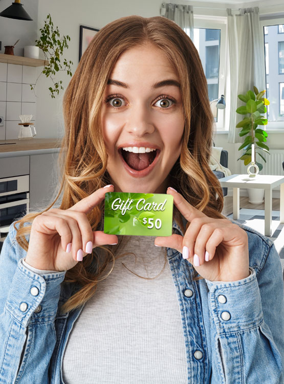 Smiling young woman holding a $50 gift card.