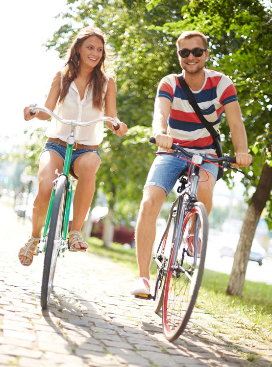 Young couple riding bikes. 