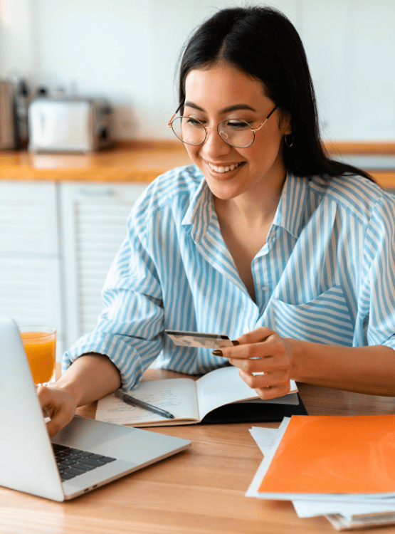 Woman shopping online and paying for merchandise with a debit/credit card. 