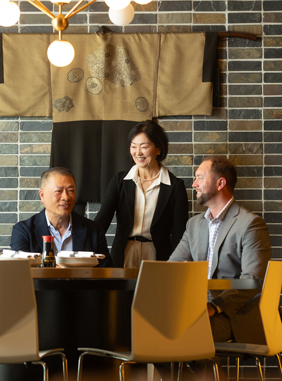The owners of Hiro88 posing for a photo with a member of Cornhusker Bank