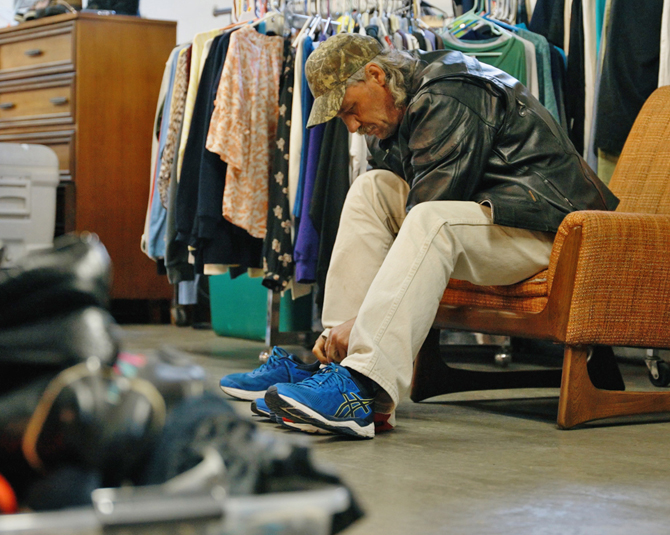 Men at the Day Without Shoes trying on his new shoes