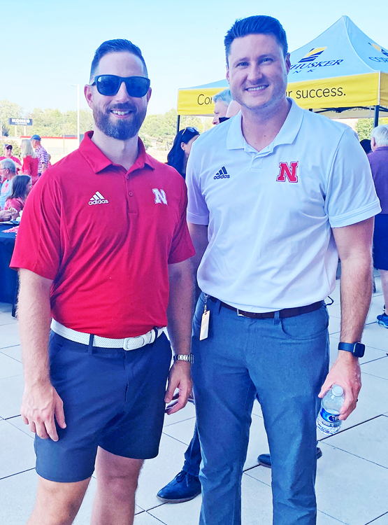 Staff members pose at our Husker Tailgate event. 