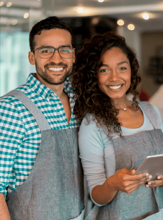Business owners with a mobile device at a restaurant. 
