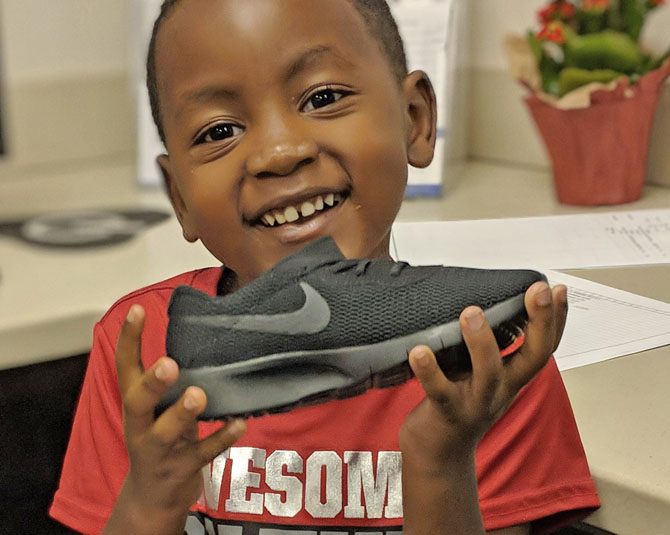 Young man showing off his new nike shoes