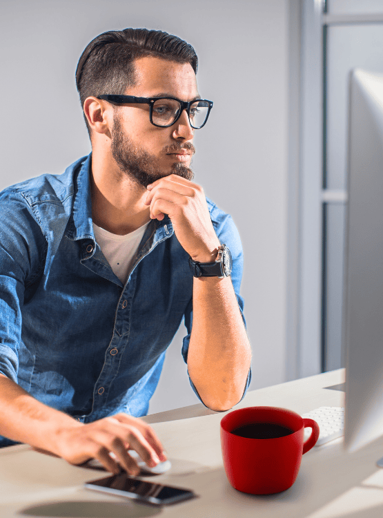 Male business owner working on computer. 