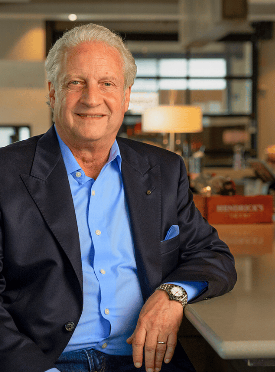 Older man in a suit sitting at the counter