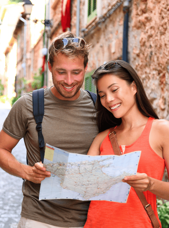 Couple looking at map while traveling. 